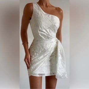 Showpo BRAILEY MINI DRESS - ONE SHOULDER WRAP FRONT DRESS IN WHITE JACQUARD
